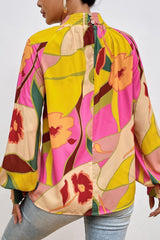 Blusa de cuello alto con mangas abullonadas y estampado floral
